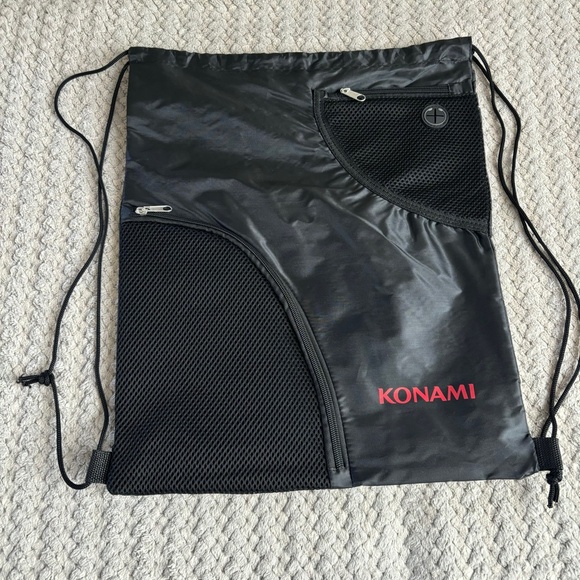 Konami Backpack Solid Black Red Lettering Zipper Compartments Drawstring NWOT - Picture 1 of 3